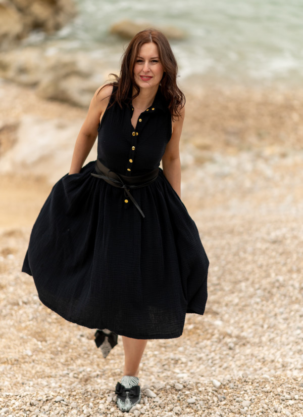 Žena v čiernych mušelínových šatách od Love Colors pri mori
